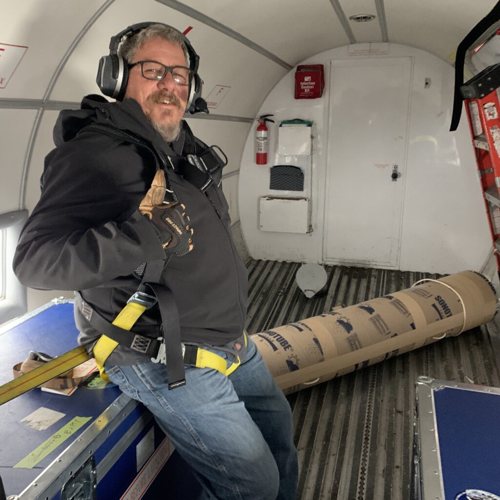 Gerald Cirtwill, Flight engineer from Kenn Borek Air, with the APEX deployment tube in the background